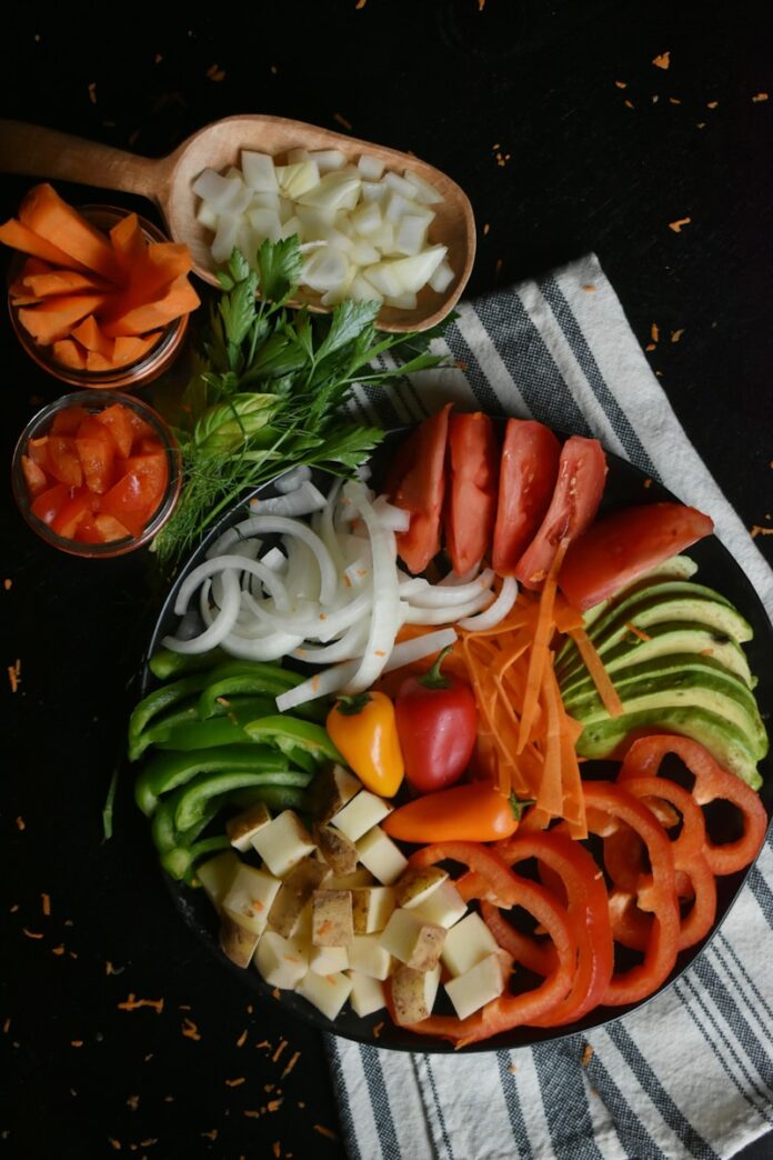 Photo by Mariah Hewines sliced tomato and green vegetable salad